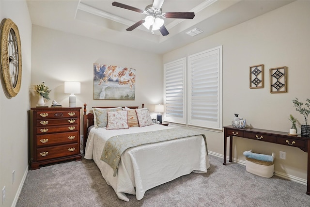 bedroom featuring carpet flooring, visible vents, baseboards, and a raised ceiling