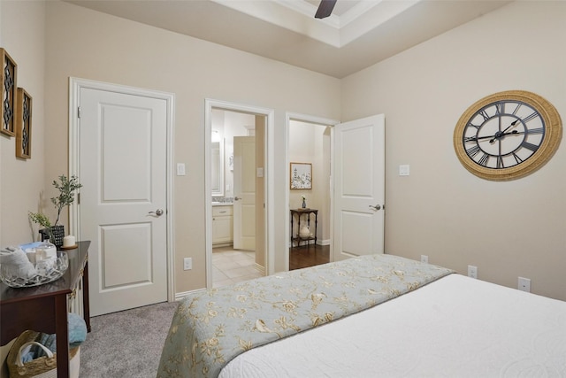 bedroom featuring light carpet and connected bathroom