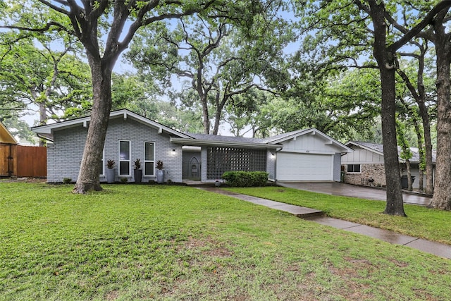 824 Wheelwood Dr, Hurst, TX 76053 - view of front of house featuring driveway, brick siding, fence, a garage, and a front lawn