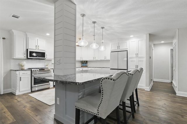 824 Wheelwood Dr, Hurst, TX 76053 - kitchen with stainless steel gas range, baseboards, a breakfast bar area, and white refrigerator