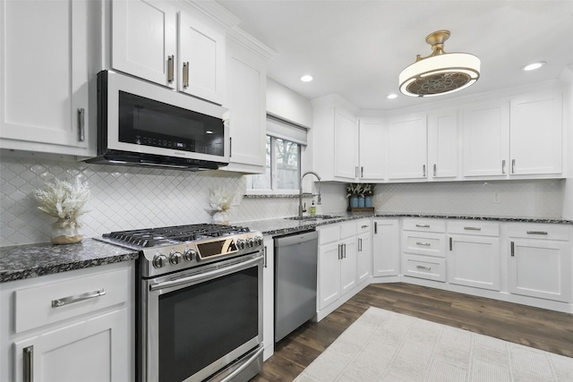 824 Wheelwood Dr, Hurst, TX 76053 - kitchen with white cabinets, stainless steel appliances, dark wood-style flooring, and a sink