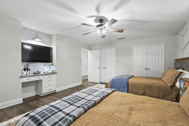 824 Wheelwood Dr, Hurst, TX 76053 - bedroom featuring built in study area, dark wood-type flooring, multiple closets, visible vents, and baseboards