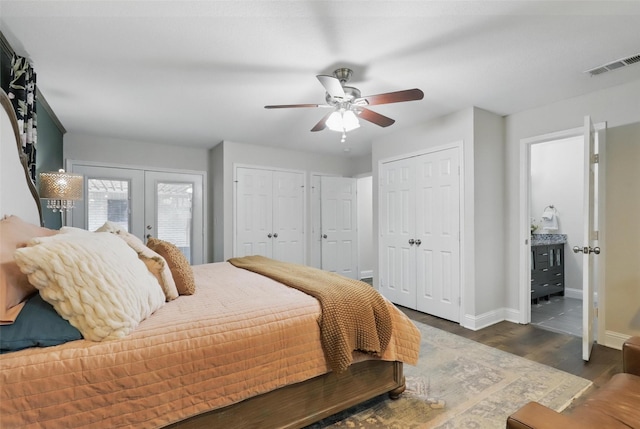 824 Wheelwood Dr, Hurst, TX 76053 - bedroom featuring wood finished floors, french doors, two closets, visible vents, and baseboards