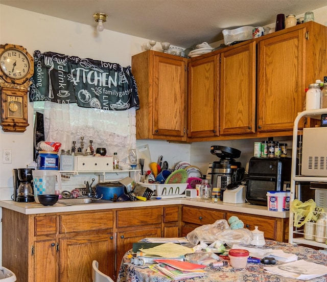 307 W Front St, Sunset, TX 76270 - kitchen featuring brown cabinetry and light countertops