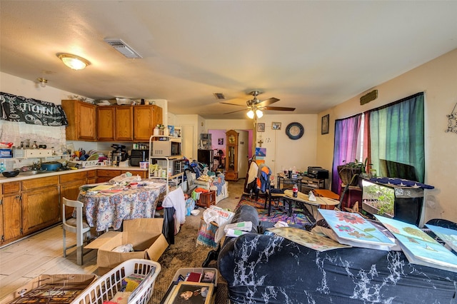 307 W Front St, Sunset, TX 76270 - interior space with brown cabinetry, ceiling fan, visible vents, a sink, and light countertops