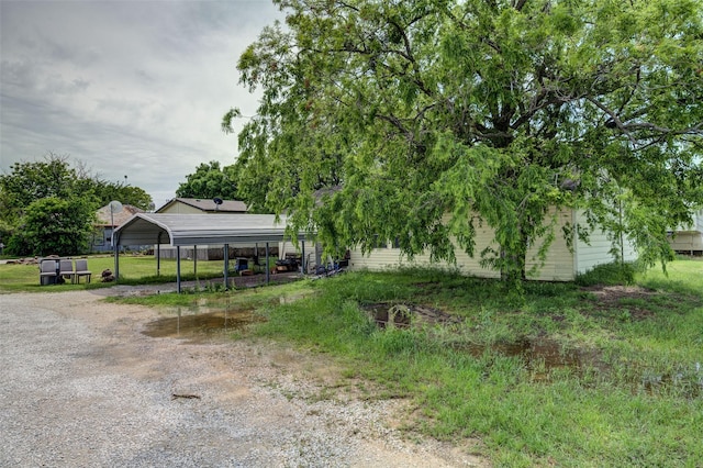 307 W Front St, Sunset, TX 76270 - view of yard featuring a detached carport and driveway
