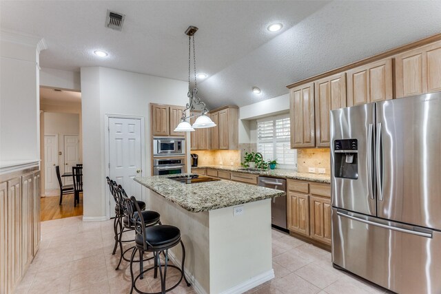 6712 Bluffview Dr, Fort Worth, TX 76132 - kitchen featuring appliances with stainless steel finishes, light tile patterned floors, tasteful backsplash, a center island, and vaulted ceiling