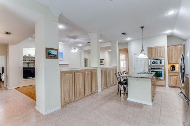 6712 Bluffview Dr, Fort Worth, TX 76132 - kitchen with appliances with stainless steel finishes, light tile patterned floors, ceiling fan, light stone counters, and a kitchen island
