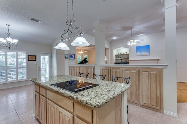 6712 Bluffview Dr, Fort Worth, TX 76132 - kitchen with ceiling fan, black electric cooktop, light tile patterned flooring, a kitchen island, and a textured ceiling
