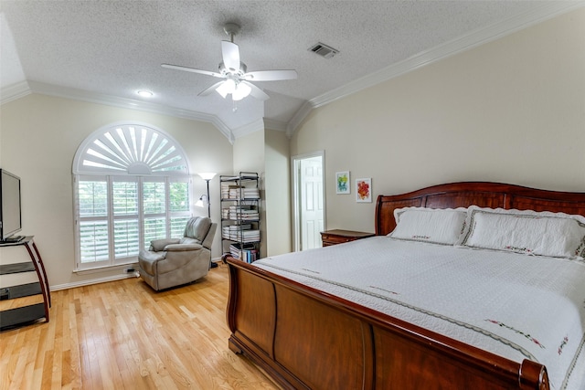 6712 Bluffview Dr, Fort Worth, TX 76132 - bedroom featuring lofted ceiling, light wood-type flooring, a textured ceiling, ornamental molding, and a ceiling fan