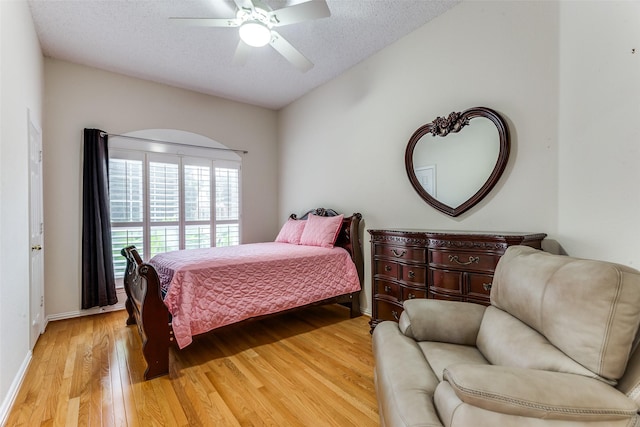 6712 Bluffview Dr, Fort Worth, TX 76132 - bedroom with light wood-style floors, baseboards, a textured ceiling, and ceiling fan