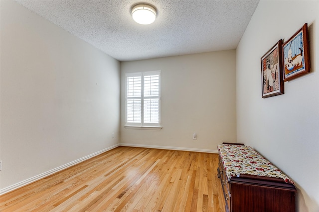 6712 Bluffview Dr, Fort Worth, TX 76132 - spare room featuring wood finished floors, a textured ceiling, and baseboards