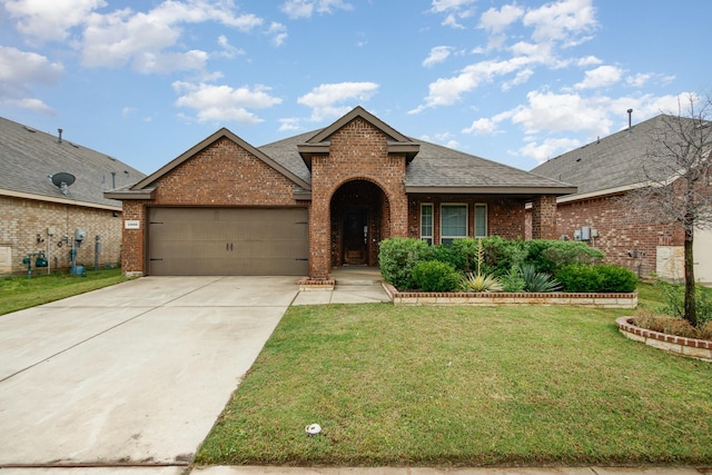 4605 Ashmark Rd, Little Elm, TX 76227 - view of front of home featuring a garage, a front lawn, brick siding, and a shingled roof