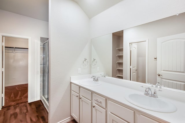 4605 Ashmark Rd, Little Elm, TX 76227 - full bathroom featuring a sink, a walk in closet, a stall shower, and wood finished floors