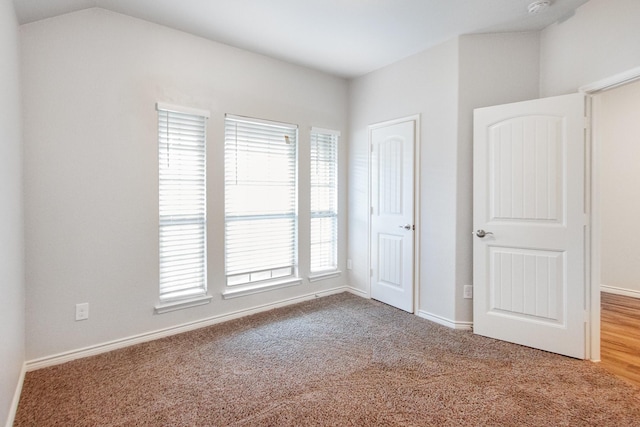 4605 Ashmark Rd, Little Elm, TX 76227 - unfurnished bedroom featuring baseboards, lofted ceiling, and carpet floors