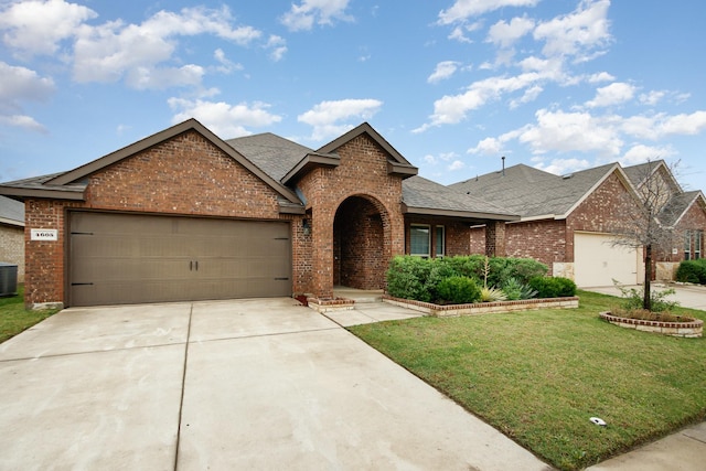 4605 Ashmark Rd, Little Elm, TX 76227 - view of front of house with central AC, roof with shingles, a front yard, brick siding, and driveway