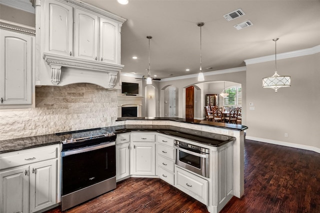 5807 Pebble Beach Dr, Granbury, TX 76049 - kitchen featuring appliances with stainless steel finishes, dark countertops, a peninsula, ornamental molding, and decorative backsplash