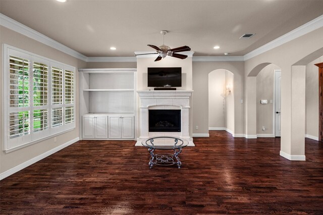 5807 Pebble Beach Dr, Granbury, TX 76049 - unfurnished living room with arched walkways, ornamental molding, a ceiling fan, wood finished floors, and baseboards