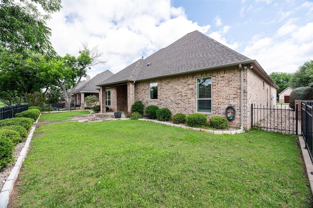 5807 Pebble Beach Dr, Granbury, TX 76049 - rear view of property featuring a shingled roof, brick siding, and a patio area