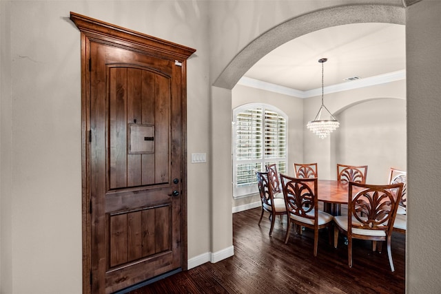 5807 Pebble Beach Dr, Granbury, TX 76049 - entryway with dark wood-style floors, crown molding, arched walkways, baseboards, and a chandelier