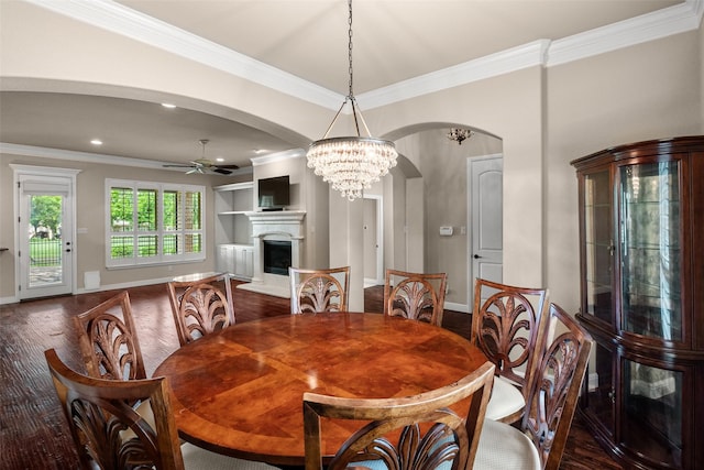 5807 Pebble Beach Dr, Granbury, TX 76049 - dining space with a ceiling fan, arched walkways, crown molding, a fireplace with raised hearth, and dark wood-style floors