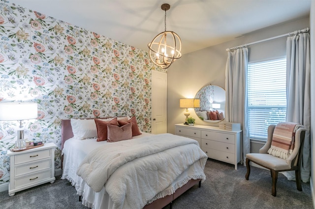 bedroom with a chandelier, wallpapered walls, and dark colored carpet