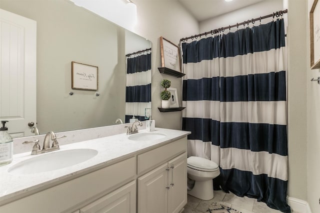 bathroom with double vanity, toilet, tile patterned flooring, and a sink