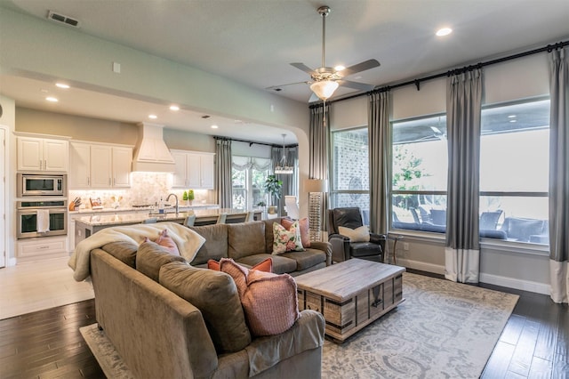 living area featuring visible vents, dark wood-style flooring, ceiling fan, and recessed lighting