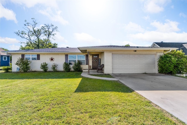 single story home with concrete driveway, a garage, a front lawn, and brick siding