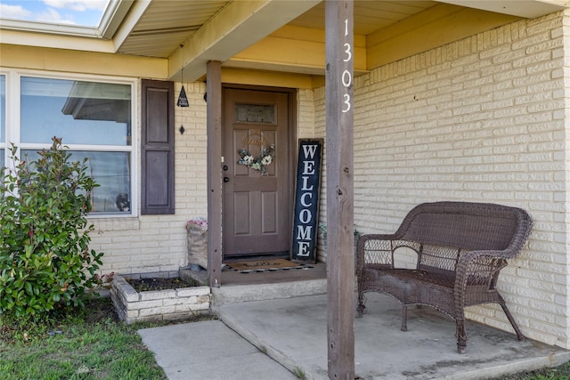 view of exterior entry with brick siding