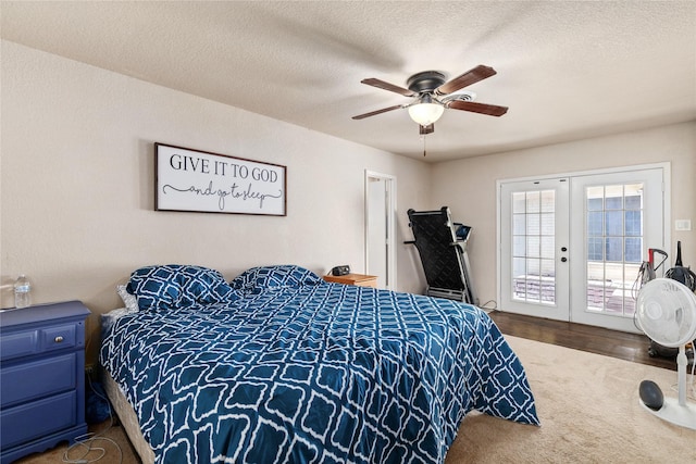 bedroom featuring carpet floors, a textured ceiling, access to outside, and french doors
