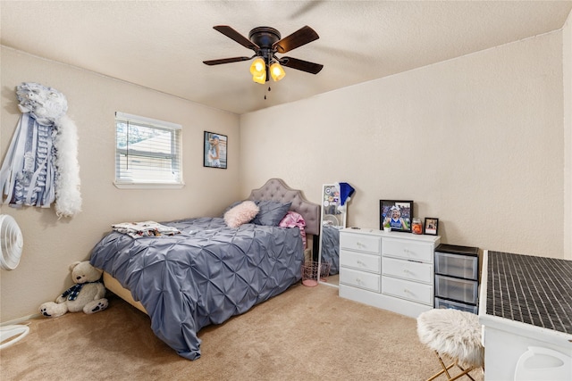 bedroom with a ceiling fan and carpet floors
