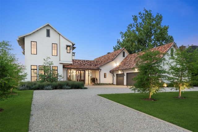 5747 Charlestown Dr, Dallas, TX 75230 - mediterranean / spanish-style house with driveway, stucco siding, a garage, and a front yard