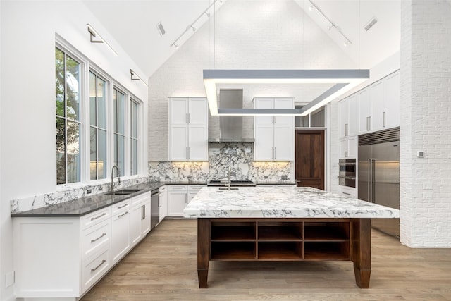 5747 Charlestown Dr, Dallas, TX 75230 - kitchen with a sink, open shelves, stainless steel appliances, rail lighting, and wall chimney range hood