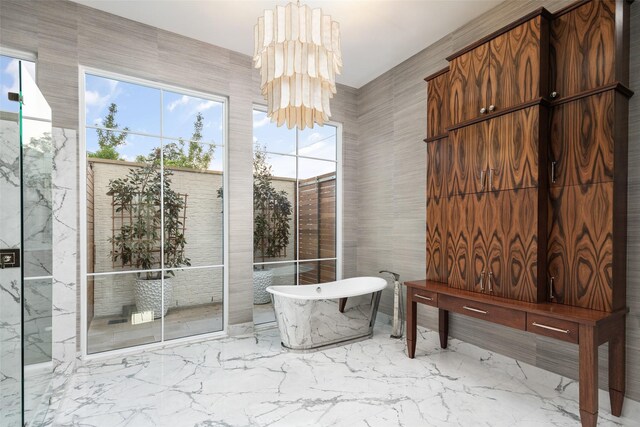 5747 Charlestown Dr, Dallas, TX 75230 - full bathroom featuring a soaking tub, an inviting chandelier, and marble finish floor