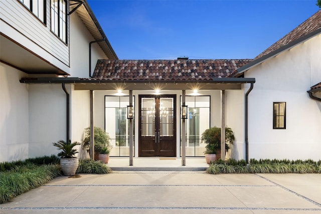 5747 Charlestown Dr, Dallas, TX 75230 - property entrance featuring a tile roof, stucco siding, and french doors