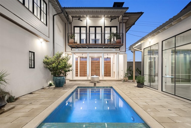 5747 Charlestown Dr, Dallas, TX 75230 - back of house with a patio area, french doors, an outdoor pool, a balcony, and stucco siding