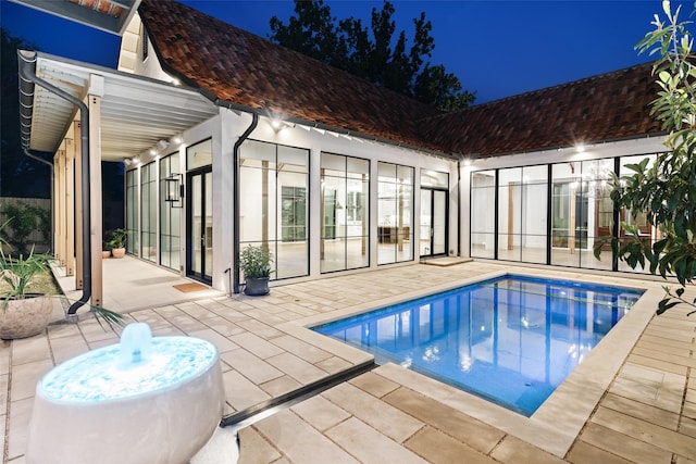 5747 Charlestown Dr, Dallas, TX 75230 - pool at night with a patio area and an outdoor pool