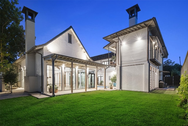 5747 Charlestown Dr, Dallas, TX 75230 - back of property featuring a patio, a chimney, and a lawn