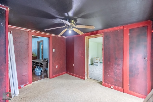unfurnished bedroom featuring carpet flooring and ceiling fan