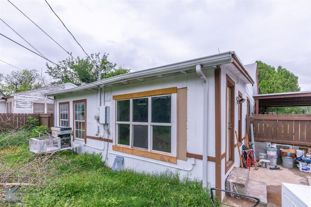 view of side of property featuring fence