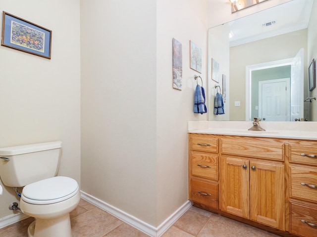 bathroom with baseboards, tile patterned floors, toilet, vanity, and ornamental molding