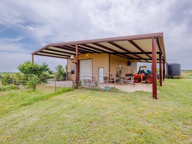 back of property with a detached garage and an outbuilding