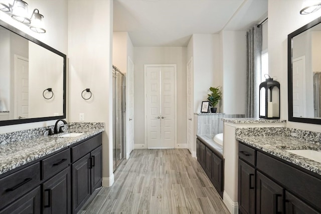 1333 Wilderness Ln, Forney, TX 75126 - bathroom with baseboards, two vanities, a sink, and wood finished floors