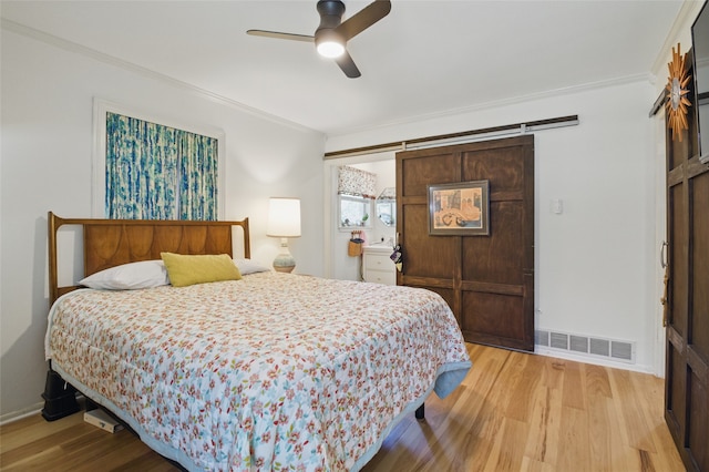bedroom featuring baseboards, ornamental molding, ceiling fan, visible vents, and light wood-type flooring