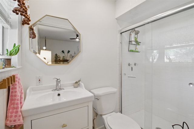 full bath with toilet, vanity, and a shower stall