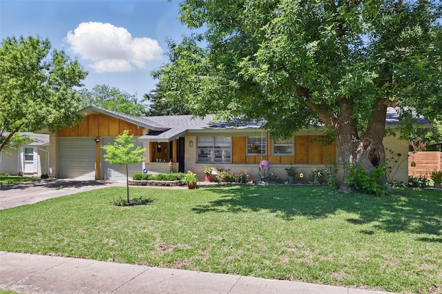 ranch-style home featuring driveway, a garage, brick siding, and a front yard