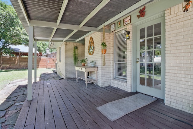 wooden terrace with covered porch and fence