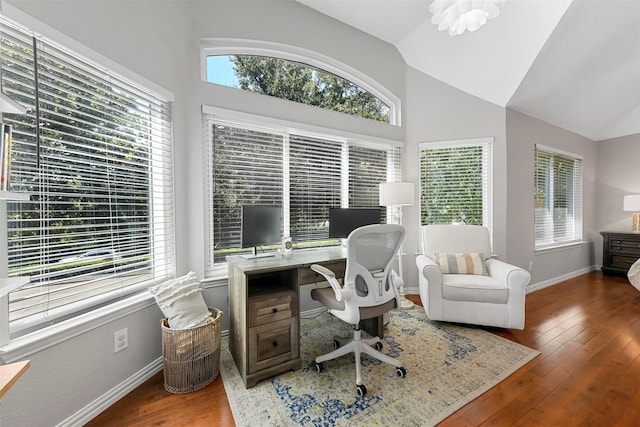office area featuring baseboards, a wealth of natural light, hardwood / wood-style floors, and high vaulted ceiling