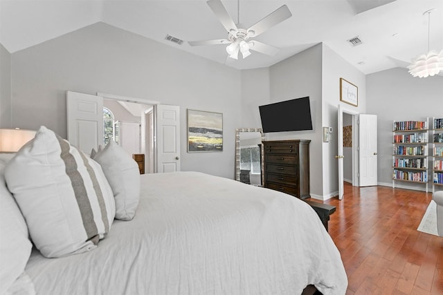 bedroom featuring a ceiling fan, visible vents, wood finished floors, and baseboards